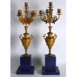 A PAIR OF FRENCH LOUIS XV STYLE ORMOLU AND LAPIS LAZULI FOUR BRANCH CANDLEABRA upon stepped bases.