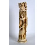 A LATE 19TH CENTURY JAPANESE MEIJI PERIOD CARVED IVORY OKIMONO modelled as a male holding a staff