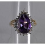 A 9CT GOLD PEAR SHAPED AMETHYST AND DIAMOND RING.