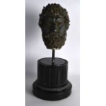 AN ANTIQUE PAINTED PLASTER HEAD imitating a Roman Bronze bust. 1Ft 5ins high.