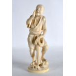 A GOOD EARLY 20TH CENTURY JAPANESE MEIJI PERIOD CARVED IVORY OKIMONO modelled as a fisherman holding