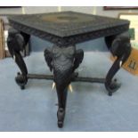 A GOOD CARVED CEYLONESE EBONY TABLE, with carved elephant features. 2 ft 1ins x 2 ft.