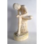 A GOOD 19TH CENTURY ITALIAN CARVED ALABASTER FIGURE OF THE THORN PICKER modelled seated upon a rocky