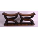 A GOOD AFRICAN CARVED HARDWOOD DOUBLE ENDED PILLOW of scrolling form with subtle engraved