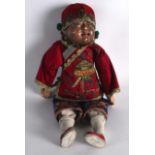 AN EARLY 20TH CENTURY MONGOLIAN FIGURE OF A DOLL modelled in silk robes, embellished in foliage.