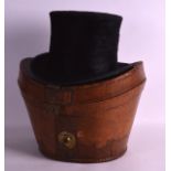 AN ANTIQUE LEATHER CASED TOP HAT.