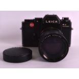 A LEICA LEITZ R3 ELECTRONIC CAMERA the lens stamped Elmarit-R 1:2.8/135, Leitz Wetzlar 2298169.