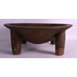 AN EARLY 20TH CENTURY AFRICAN CARVED WOODEN BOWL in the form of an animal, supported upon four