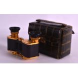 A PAIR OF VINTAGE CARL ZEISS BINOCULARS within a croc skin case. 4.25ins wide.