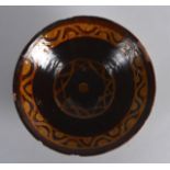 A Persian Brown Glazed Bowl Nishapur, 9th/10th Century, painted with yellow motifs. 7.75ins