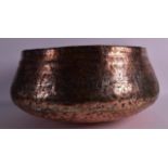 A 12TH CENTURY PERSIAN COPPER ALLOY BOWL engraved with motifs, foliage and vines. 1Ft 3ins diameter.