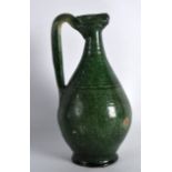 A PERSIAN GREEN GLAZED JUG 9th/10th Century, with high loop handle and incised banding. 8.5ins high.