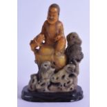 AN 18TH/19TH CENTURY CHINESE SOAPSTONE FIGURE OF A BUDDHA upon a pierced open work, inset with