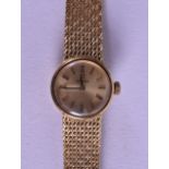 A HEAVY 18CT YELLOW GOLD OMEGA LADIES WRISTWATCH with 18ct gold strap. 30.3 grams.