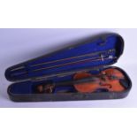 A CASED VIOLIN with two piece back, with two bows, bearing label to interior Antonius Stradiuarius
