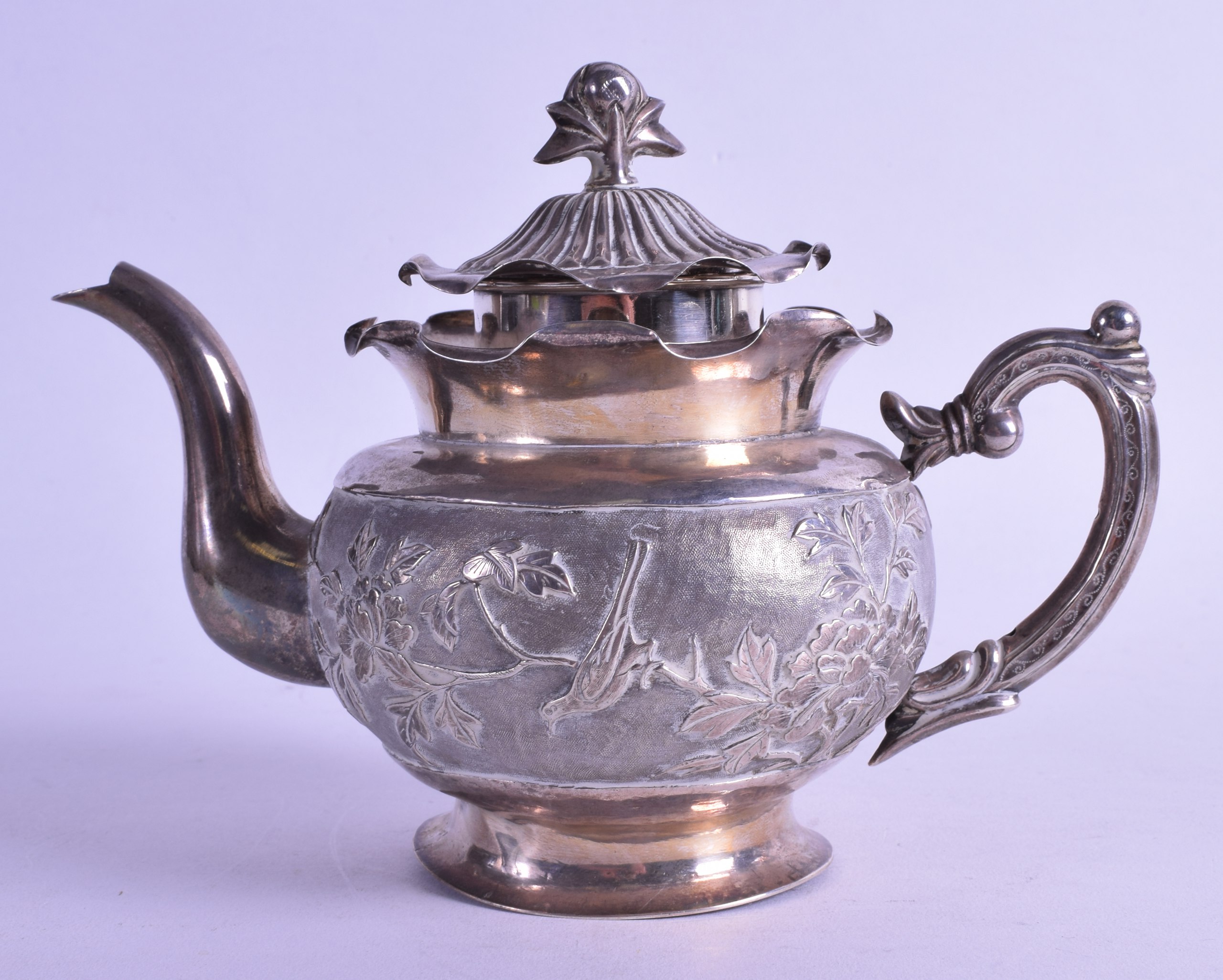 A LATE 19TH CENTURY CHINESE EXPORT SILVER TEAPOT AND COVER decorated with birds perched amongst