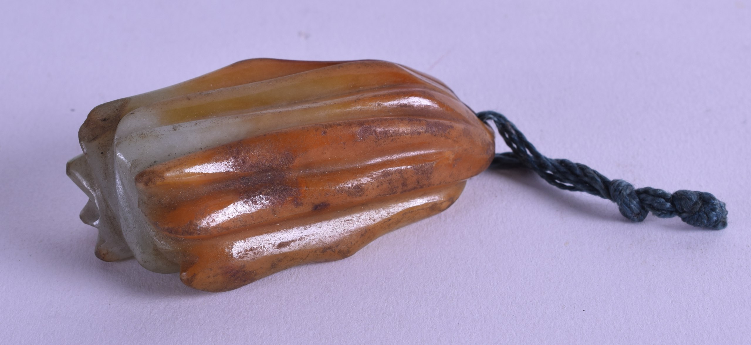 A 19TH CENTURY CHINESE CARVED MUTTON JADE PENDANT in the form of a fruiting pod. 6 cm long.