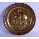 AN ARTS AND CRAFTS BRASS CHARGER in the style of Newlyn, decorated with a boat upon the water. 42 cm