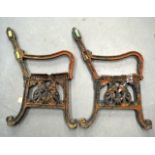 A PAIR OF VICTORIAN CAST IRON BLACK PAINTED BENCH ENDS of scrolling form.