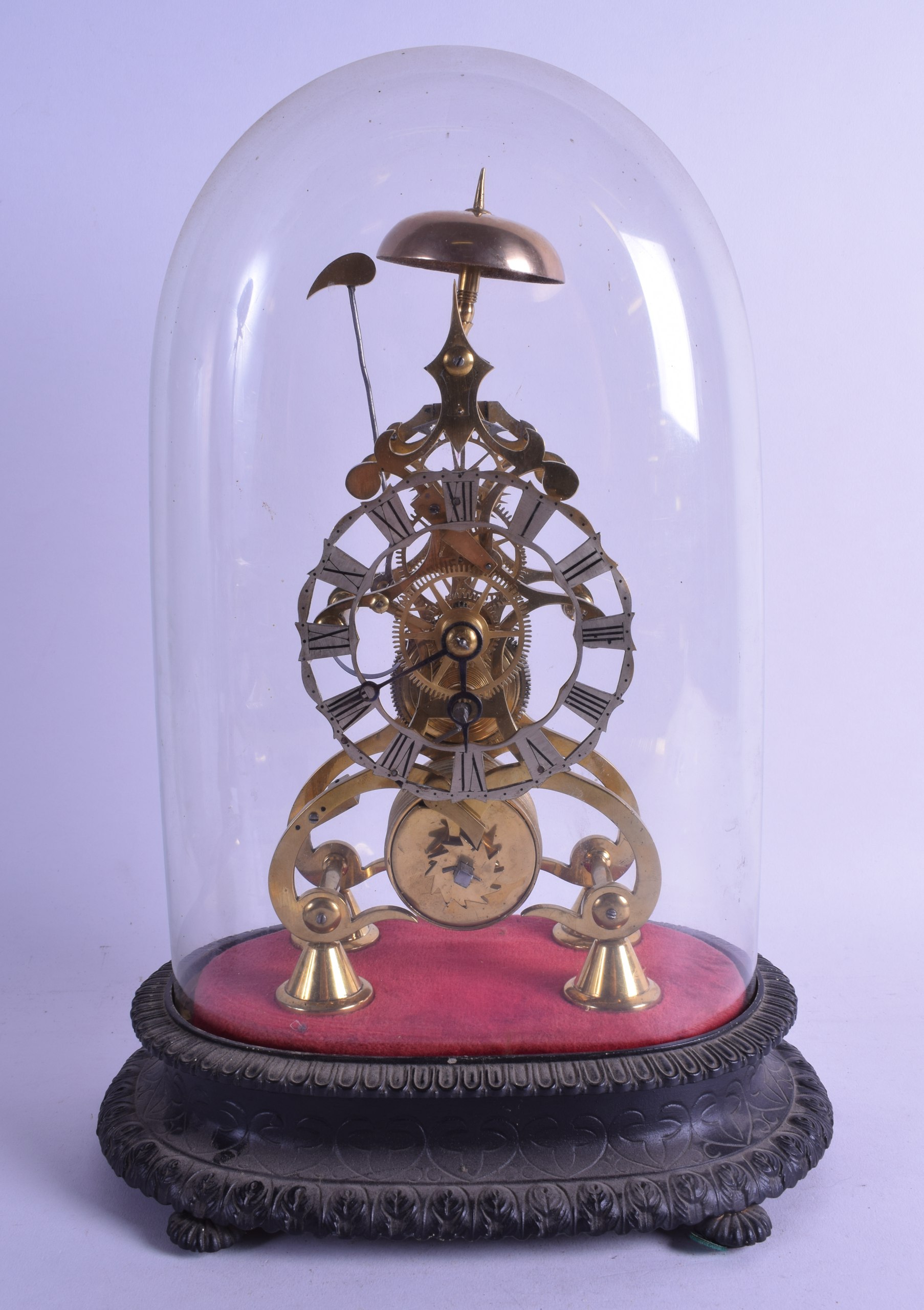 AN EARLY 20TH CENTURY BRASS SKELETON CLOCK with glass dome and fitted cast iron base. 35 cm high.