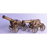 A PAIR OF BRASS FIRESIDE CANNONS. 39 cm long.