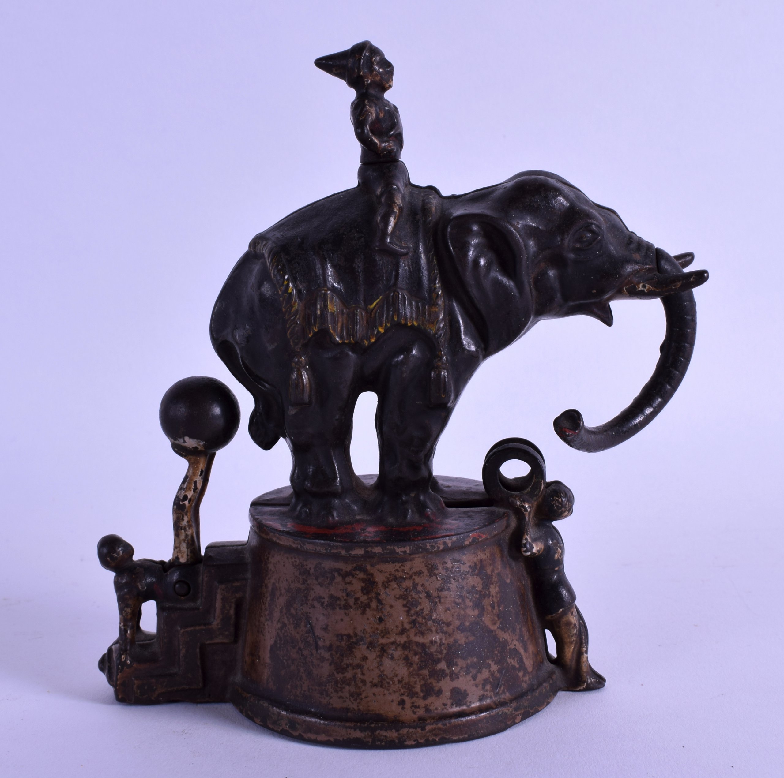 A GOOD AMERICAN ANTIQUE CAST IRON MONEY BANK in the form of a male seated upon an elephant. 15.5