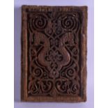 A GOOD 17TH/18TH CENTURY TURKISH CARVED WOODEN TILE formed with two opposing horse heads amongst