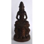 AN EARLY 20TH CENTURY CHINESE CARVED BAMBOO FIGURE OF GUANYIN modelled seated upon beasts, holding a