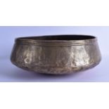 A 12TH CENTURY PERSIAN OR SYRIAN BRASS BOWL engraved with calligraphy and vines. 31 cm x 15 cm.