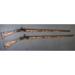 A GOOD LARGE PAIR OF LATE 19TH CENTURY ALBANIAN TOE/FLINT LOCK GUNS inlaid with various motifs.