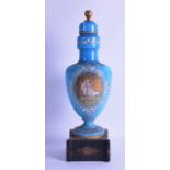 A VICTORIAN BLUE OPALINE GLASS VASE AND COVER painted with a portrait of a couple with a sheep