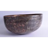 A 12TH CENTURY PERSIAN OR SYRIAN BRASS MIXED METAL BOWL engraved with calligraphy and motifs. 42