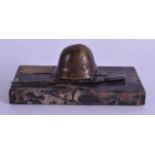 A BRONZE GERMAN HELMET AND RIFLE PAPERWEIGHT. 14.5 cm wide.