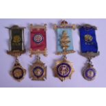 A GROUP OF THREE SILVER GILT AND ENAMEL MASONIC MEDALS together with a yellow metal masonic