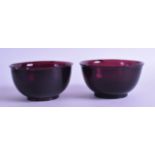 A PAIR OF EARLY 20TH CENTURY CHINESE PEKING AUBERGINE GLASS BOWLS. 11 cm diameter.