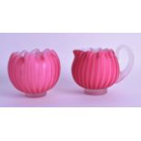 A LATE VICTORIAN PINK VASELINE GLASS JUG together with a matching sugar bowl. 8.5 cm wide. (2)