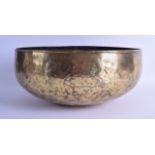 A 12TH CENTURY PERSIAN OR SYRIAN BRASS BOWL engraved with calligraphy. 34 cm x 17 cm.