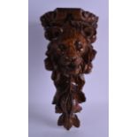 A LATE VICTORIAN CARVED OAK BRACKET in the form of a lion mask head and fruiting vines. 43 cm x 22