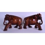 AN UNUSUAL PAIR OF CHINESE QING DYNASTY HARDWOOD WOOLLY MAMMOTH FIGURES modelled with elongated