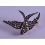 A GOLD SILVER AND DIAMOND SWALLOW BROOCH.