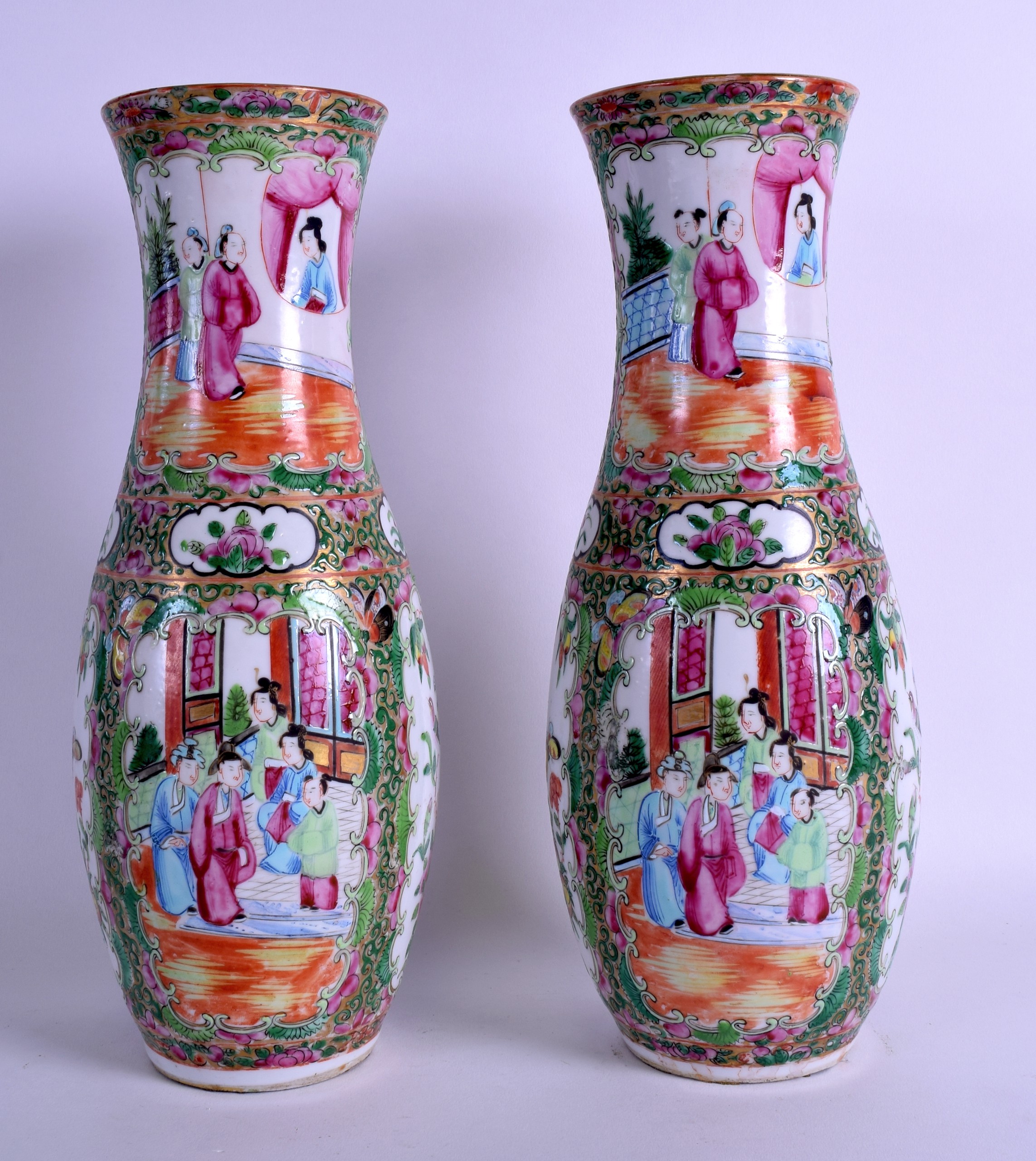 A PAIR OF 19TH CENTURY CHINESE CANTON FAMILLE ROSE VASES painted with figures and birds within