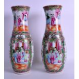 A PAIR OF 19TH CENTURY CHINESE CANTON FAMILLE ROSE VASES painted with figures and birds within