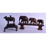 A 19TH CENTURY INDIAN BRONZE INCENSE BURNER in the form of a cow, together with a carved lignum