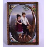 AN UNUSUAL 19TH CENTURY CONTINENTAL FRAMED PORCELAIN PLAQUE painted with a boy and girl within a