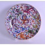 A MID 19TH CENTURY CHINESE CANTON FAMILLE ROSE PLATE painted with a central stylised dragons amongst