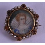 AN ANTIQUE PAINTED IVORY PORTRAIT MINIATURE set within a banding of pearls and garnets. 2 cm x 2.