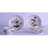 A PAIR OF 18TH CENTURY MEISSEN PORCELAIN TEACUPS AND SAUCERS painted with birds and insects.