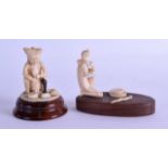 TWO EARLY 20TH CENTURY INDIAN CARVED IVORY FIGURES OF SNAKE CHARMERS each modelled upon hardwood