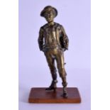 A 19TH CENTURY FRENCH BRONZE FIGURE OF A STANDING BOY modelled holding a book. 19 cm high.