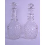 A LARGE NEAR PAIR OF 19TH CENTURY CUT GLASS DECANTERS AND STOPPERS with spiral twist ridged